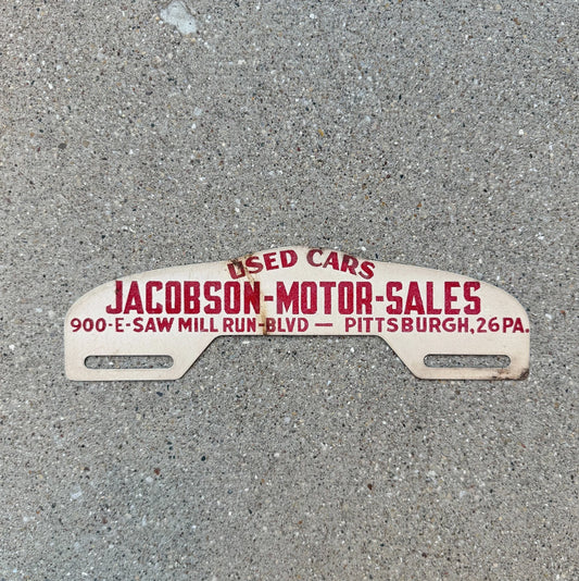 Photo of a 1950 Era Jacobson Pittsburgh Pennsylvania License Plate Topper Auto Tag Garage Decor Vintage Used Car Dealer with original patina