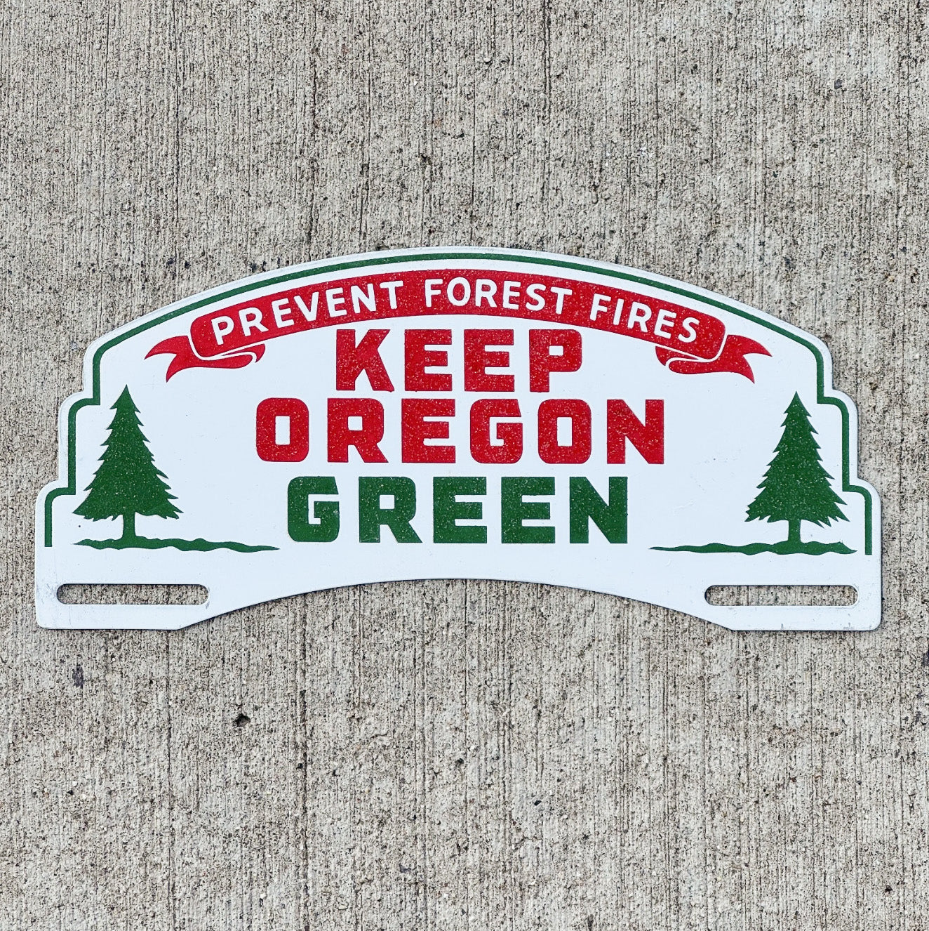 Photo of a 1950 Era Keep Oregon License Plate Topper Auto Tag Garage Decor Vintage Forest Fire Conservation with original patina