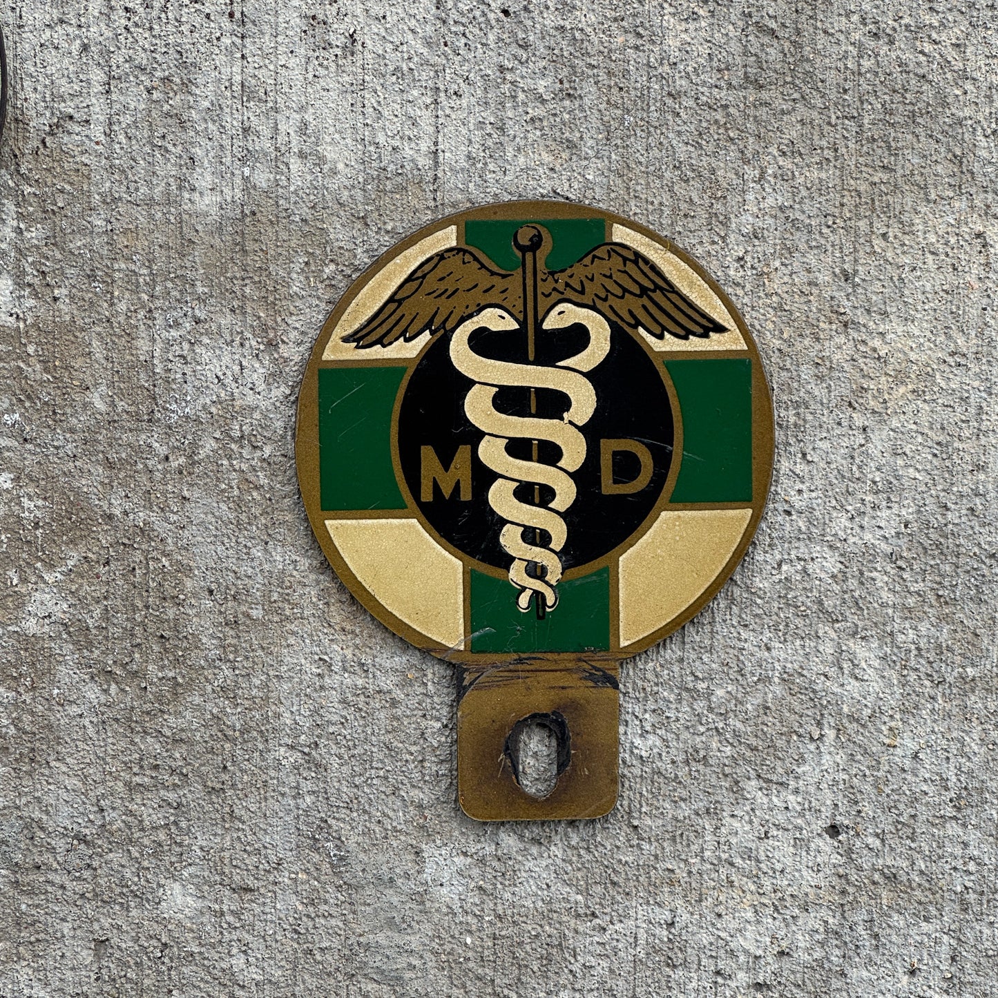 Photo of a 1950 Era MD Medical Doctor License Plate Topper Auto Tag Garage Decor Vintage Caduceus with original patina