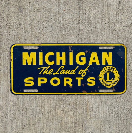 Photo of a 1950 Era Michigan Booster License Plate Auto Tag Garage Decor Vintage Land of Sports Lions Club with original patina