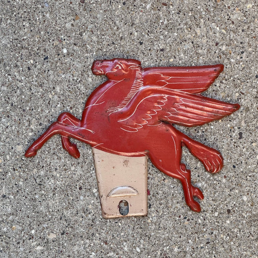 Photo of a 1950 Era Mobil Pegasus License Plate Topper Auto Peggy Gas and Oil Collectible Garage with original patina