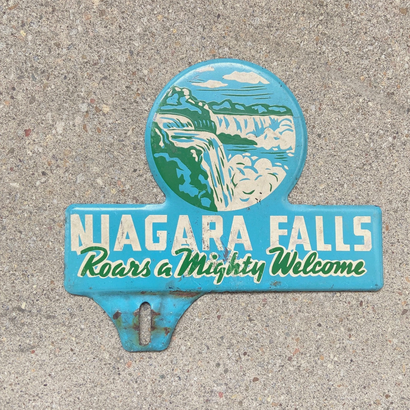 Photo of a 1950 Era Niagara Falls New York License Plate Topper Auto Tag Garage Decor Vintage Roars a Mighty Welcome with original patina