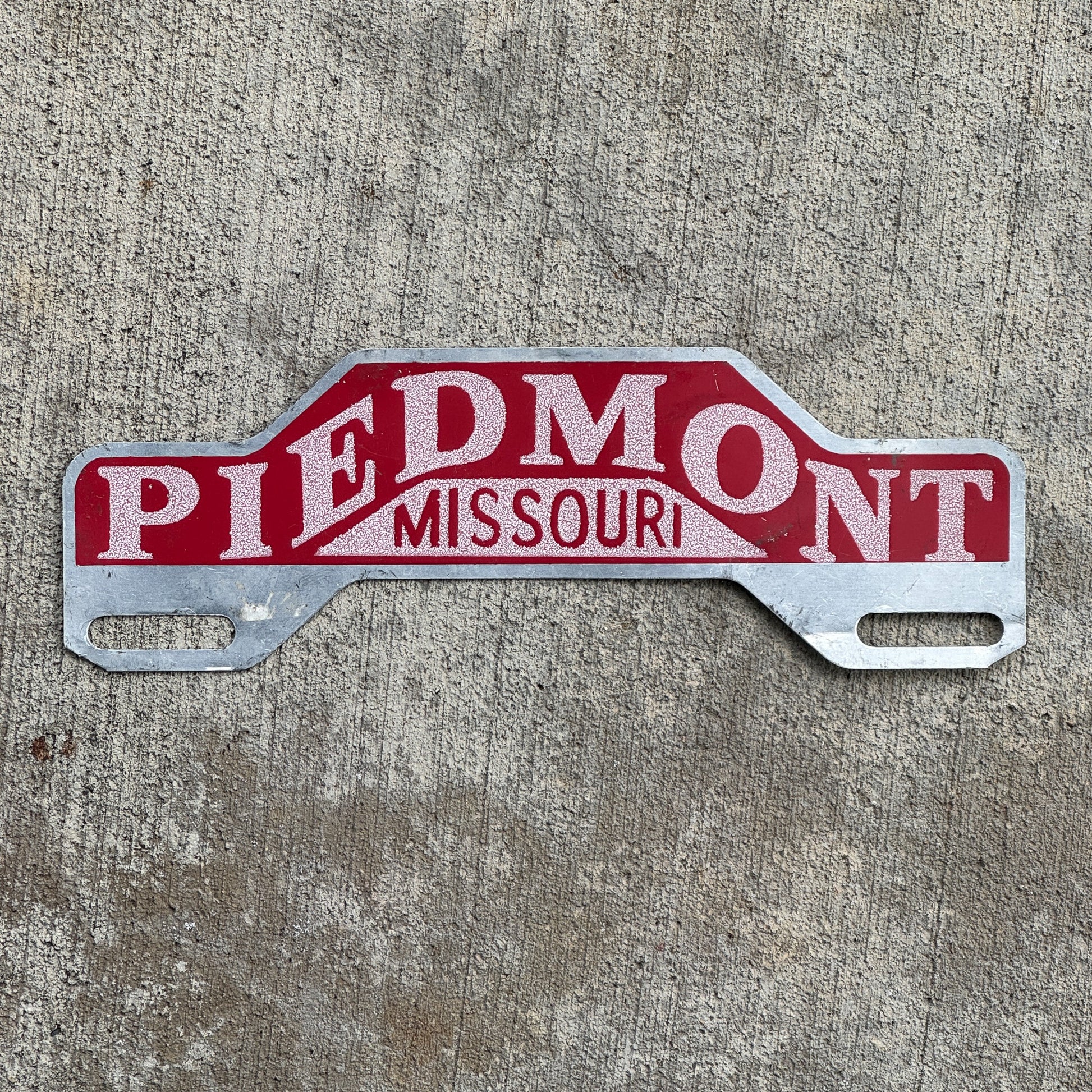 Photo of a 1950 Era Piedmont Missouri License Plate Topper Auto Tag Garage Decor Vintage Smaltz Reflective Paint with original patina
