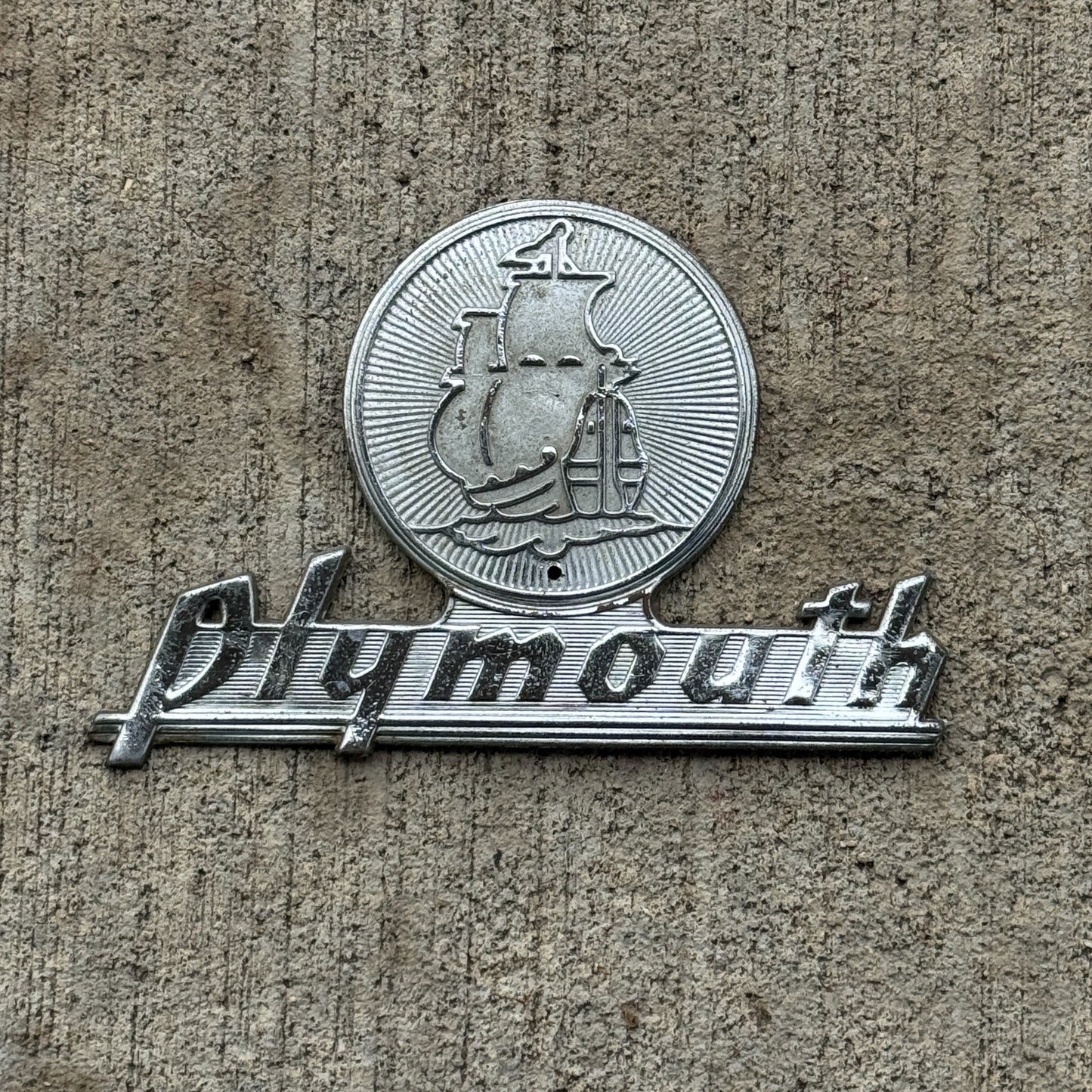 Photo of a 1950 Era Plymouth Badge Emblem Auto Tag Garage Decor Vintage with original patina