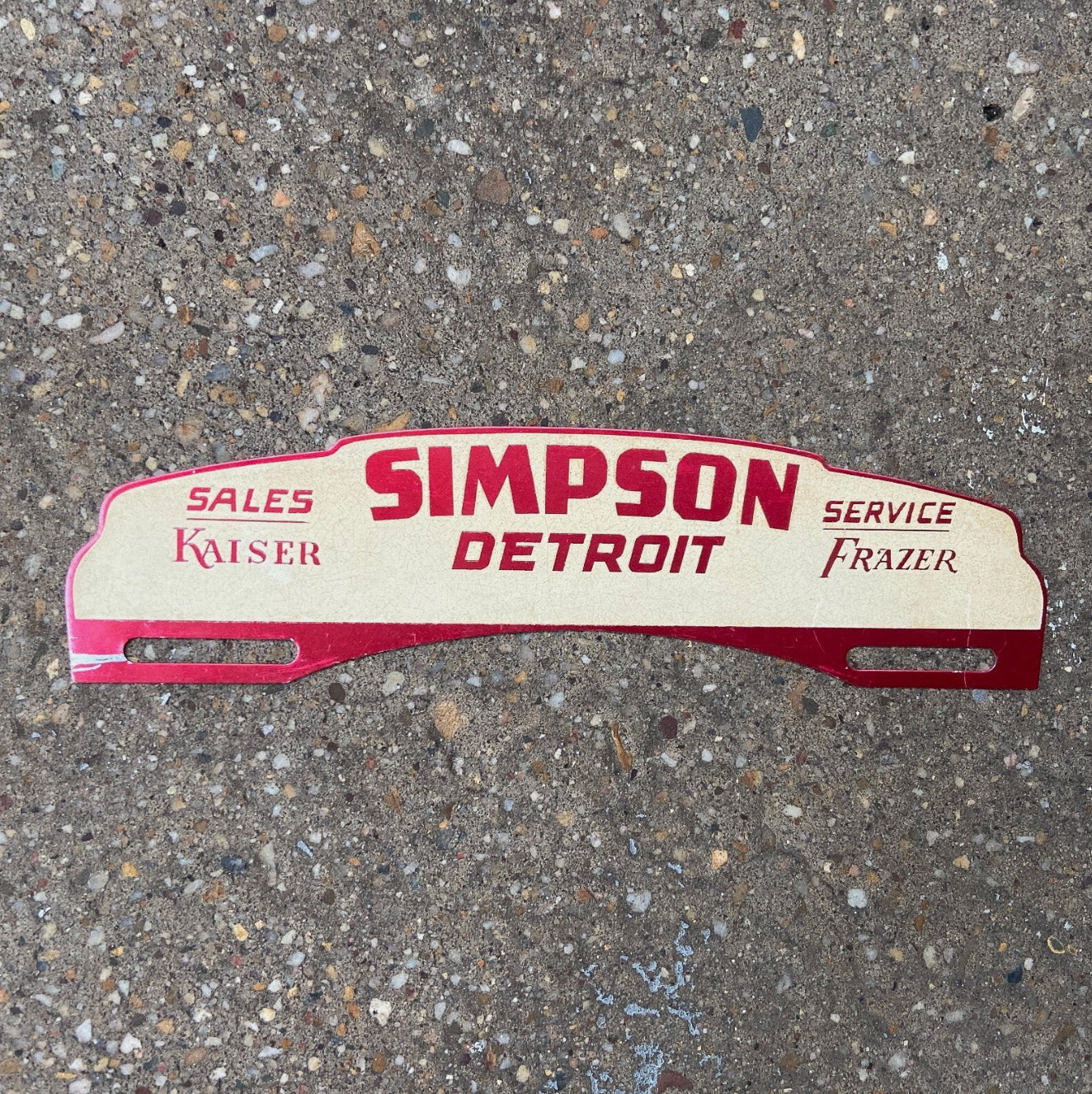 Photo of a 1950 Era Simpson Detroit Michigan License Plate Topper Auto Tag Garage Decor Vintage Car Dealer Kaiser Frazer with original patina