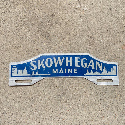 Photo of a 1950 Era Skowhegan Maine License Plate Topper Auto Tag Garage Decor Vintage Outdoors Forest Skiing Nature with original patina