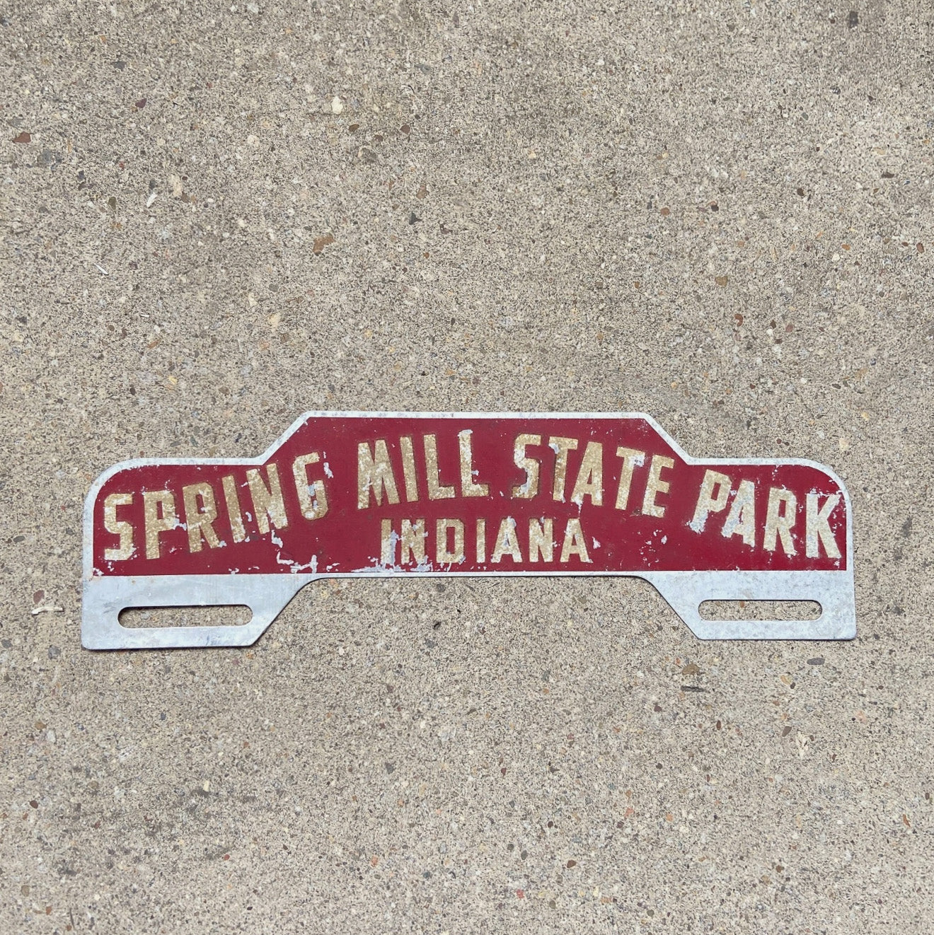 Photo of a 1950 Era Spring Mill State Park Indiana License Plate Topper Auto Tag Garage Decor Vintage Reflective Smaltz Paint with original patina