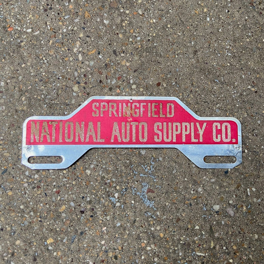 Photo of a 1950 Era Springfield National Auto Supply Co License Plate Topper Auto Tag Garage Decor Vintage Reflective Smaltz Paint with original patina