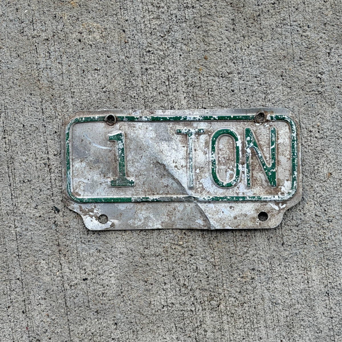 Photo of a 1950 Kansas Truck License Plate Auto Tag Garage Decor Vintage 1 Ton Weight Supplementary Topper with original patina