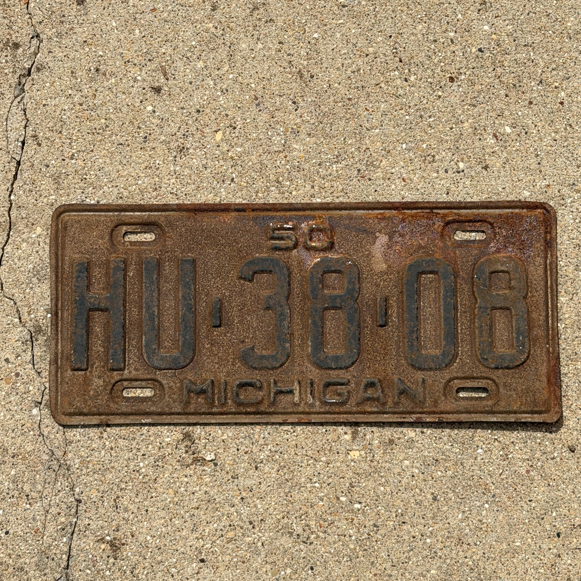 Photo of a 1950 Michigan License Plate Auto Tag Garage Decor Vintage HU 38 08 with original patina