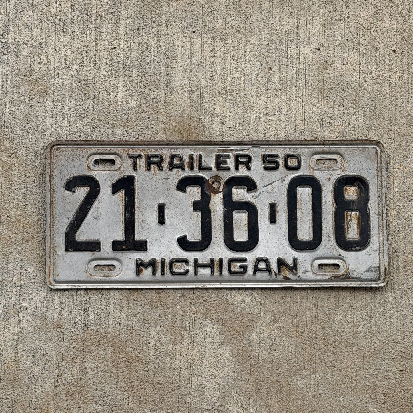 Photo of a 1950 Michigan Trailer License Plate Auto Tag Garage Decor Vintage 21 36 08 with original patina