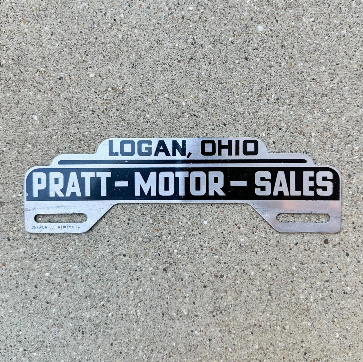 Photo of a 1950 Pratt Motor Logan Ohio License Plate Topper Auto Tag Garage Decor Vintage Classic Car Dealer Studebaker with original patina