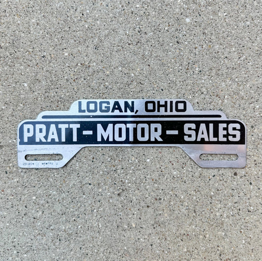 Photo of a 1950 Pratt Motor Logan Ohio License Plate Topper Auto Tag Garage Decor Vintage Classic Car Dealer Studebaker with original patina
