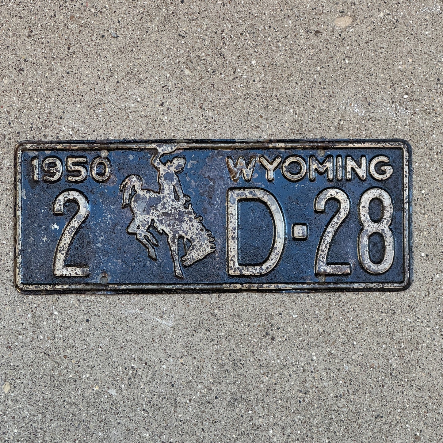 Photo of a 1950 Wyoming Dealer License Plate Auto Tag Garage Decor Vintage 2 D 28 with original patina