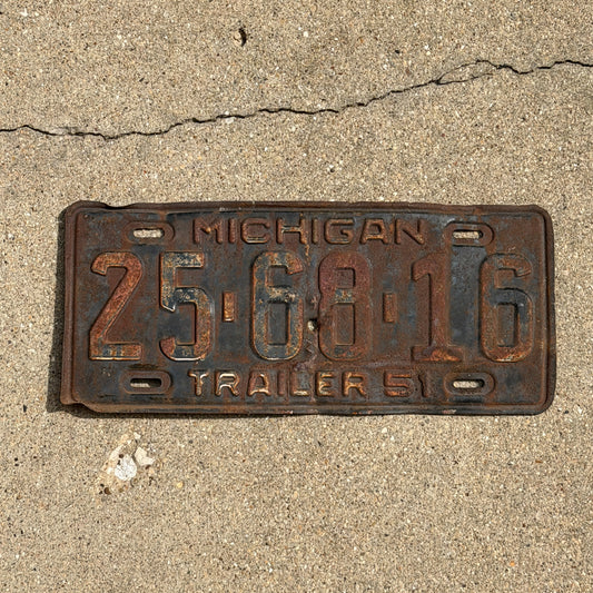 Photo of a 1951 Michigan Trailer License Plate Auto Tag Garage Decor Vintage 25 68 16 with original patina