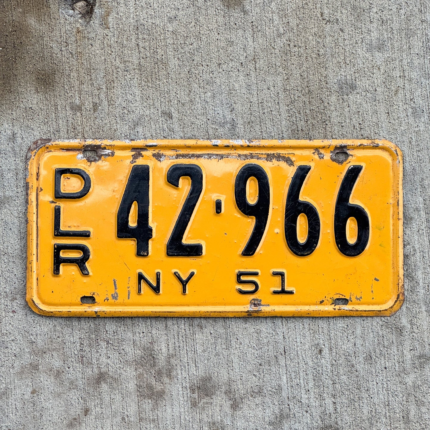 Photo of a 1951 New York Dealer License Plate Auto Tag Garage Decor Vintage 42 966 with original patina