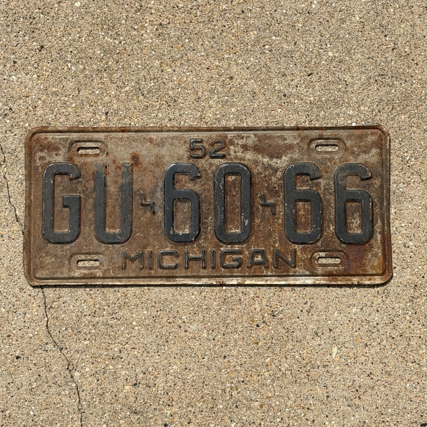 Photo of a 1952 Michigan License Plate Auto Tag Garage Decor Vintage GU 60 66 with original patina