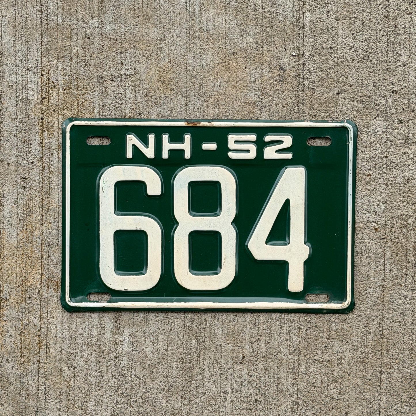 Photo of a 1952 New Hampshire License Plate Auto Tag Garage Decor Vintage Low Number Three Digit 684 with original patina