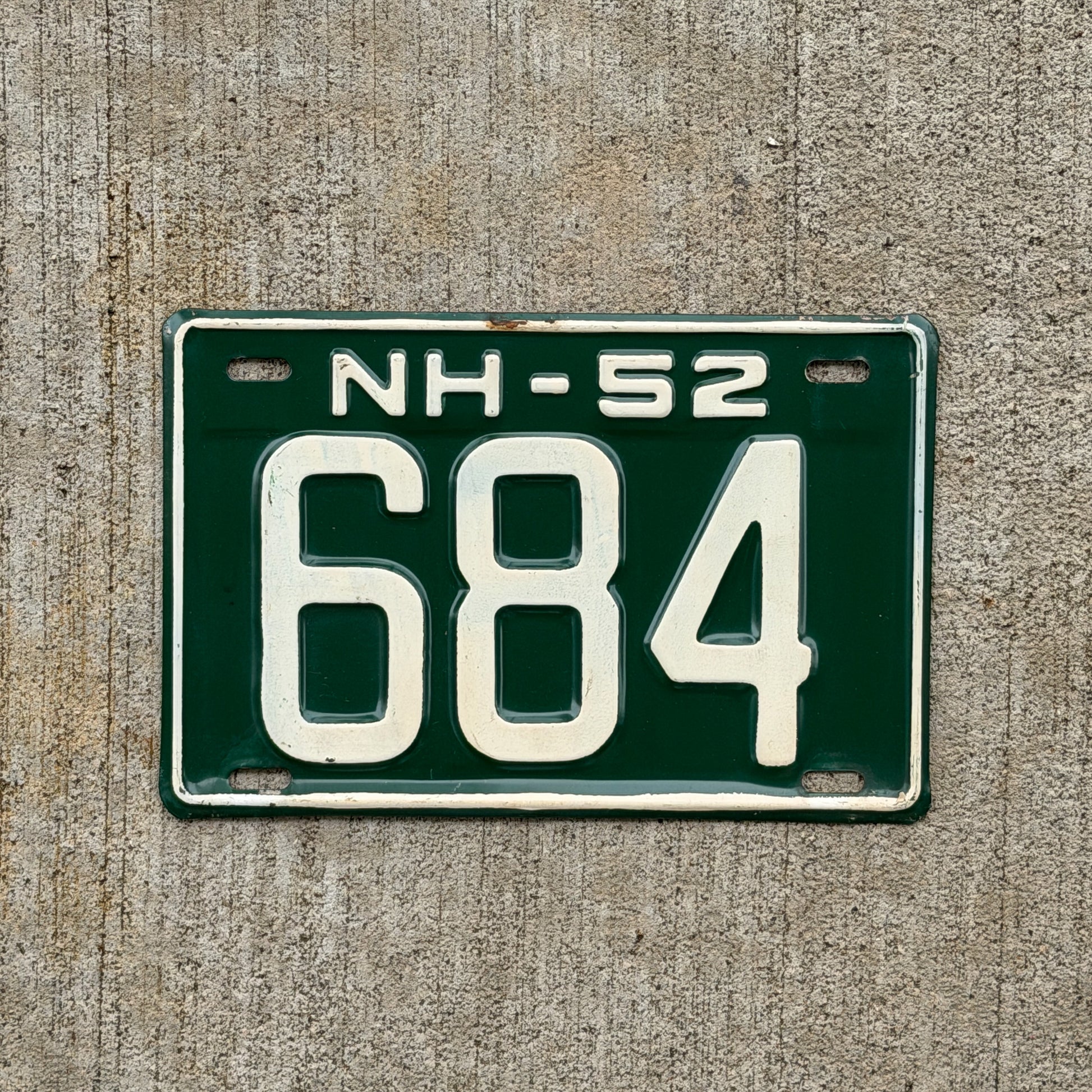 Photo of a 1952 New Hampshire License Plate Auto Tag Garage Decor Vintage Low Number Three Digit 684 with original patina