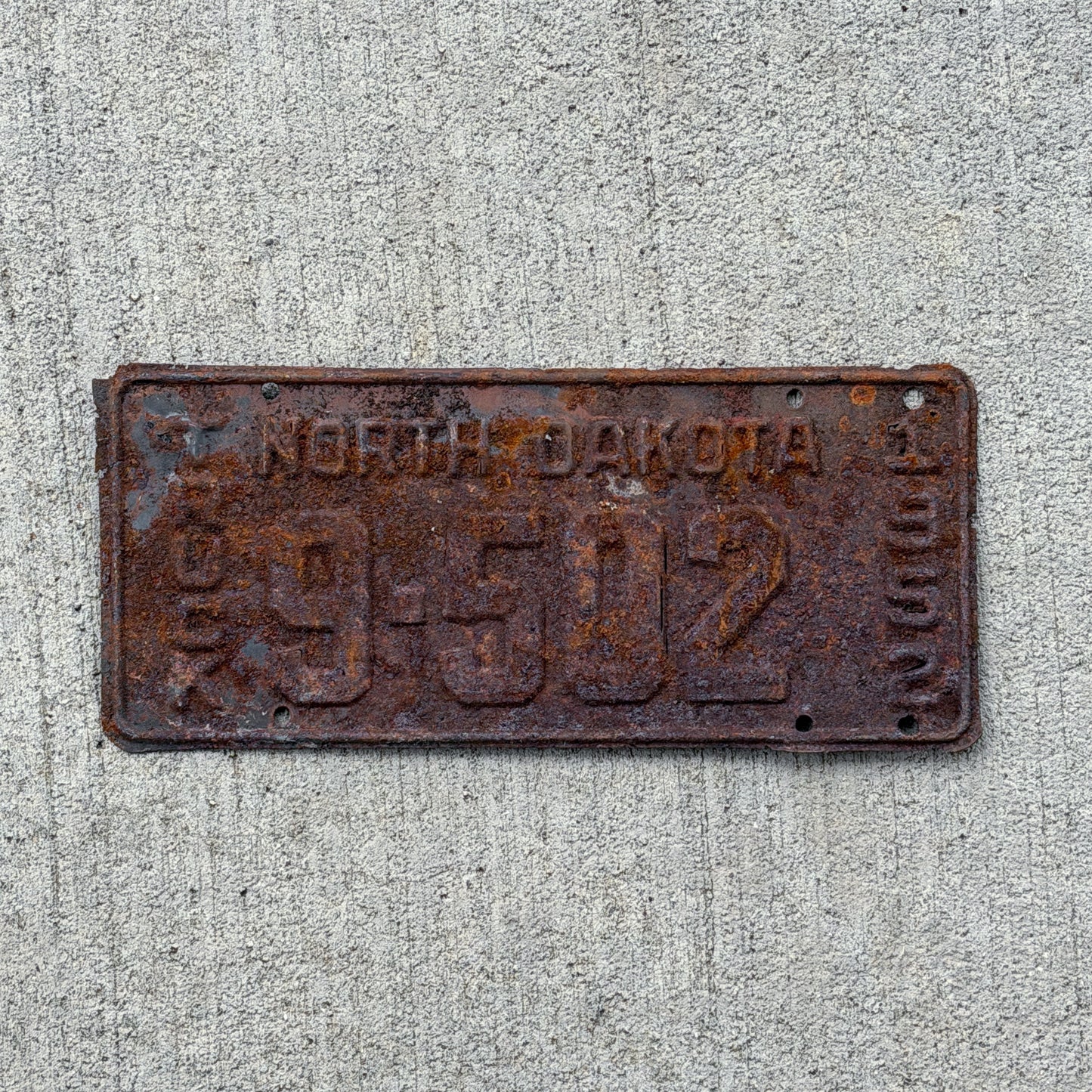 Photo of a 1952 North Dakota Truck License Plate Auto Tag Garage Decor Vintage 9502 with original patina