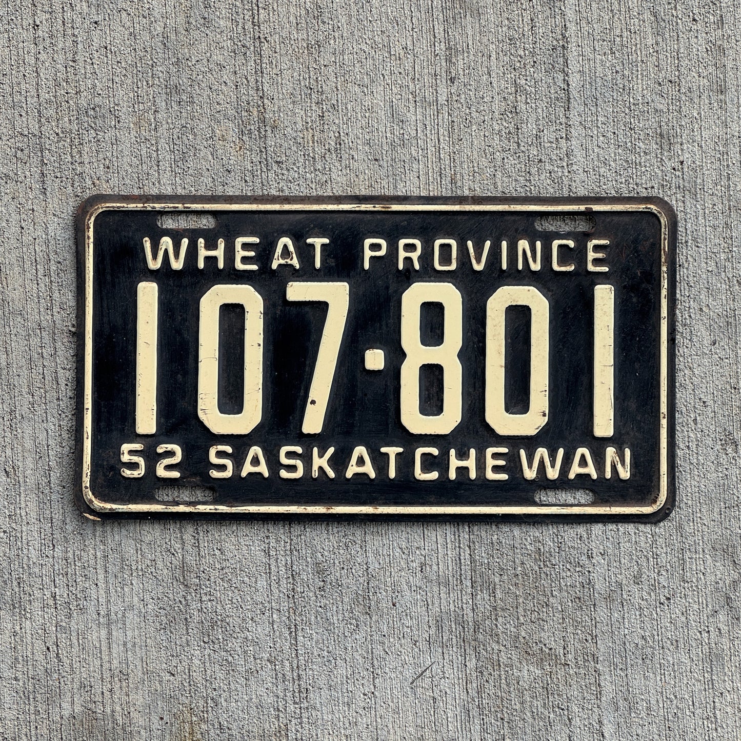 Photo of a 1952 Saskatchewan License Plate Auto Tag Garage Decor Vintage Wheat Province 107 801 with original patina