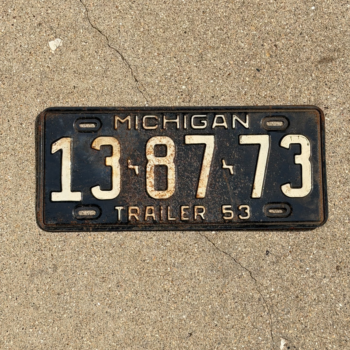 Photo of a 1953 Michigan Trailer License Plate Auto Tag Garage Decor Vintage 13 87 73 with original patina