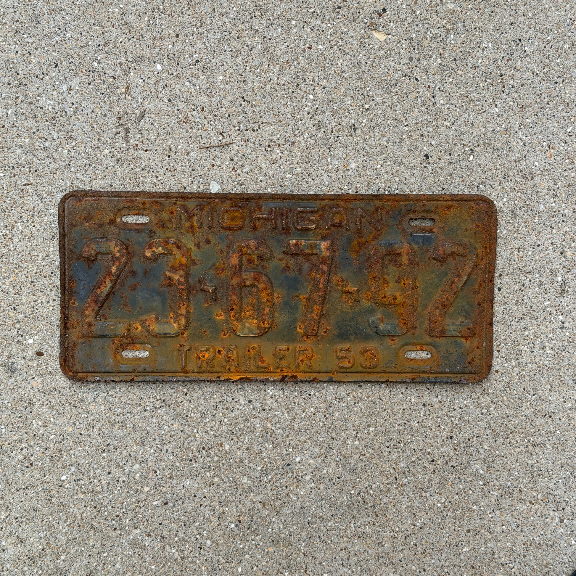 Photo of a 1953 Michigan Trailer License Plate Auto Tag Garage Decor Vintage 23 67 92 with original patina