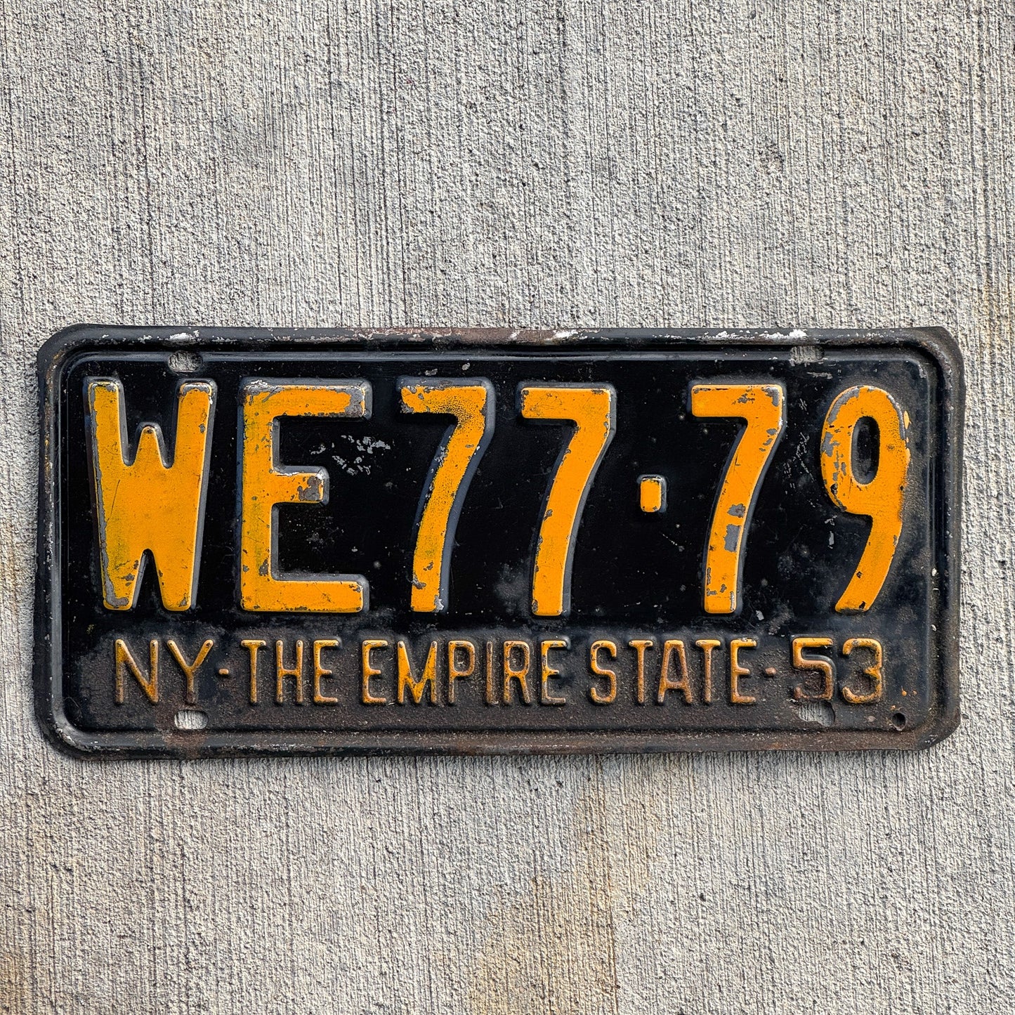 Photo of a 1953 New York License Plate Auto Tag Garage Decor Vintage DMV Clear Single Plate Year WE 77 79 with original patina