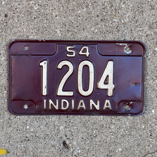 Photo of a 1954 Indiana Motorcycle License Plate Auto Tag Garage Decor Vintage Low Number Four Digit 1204 with original patina