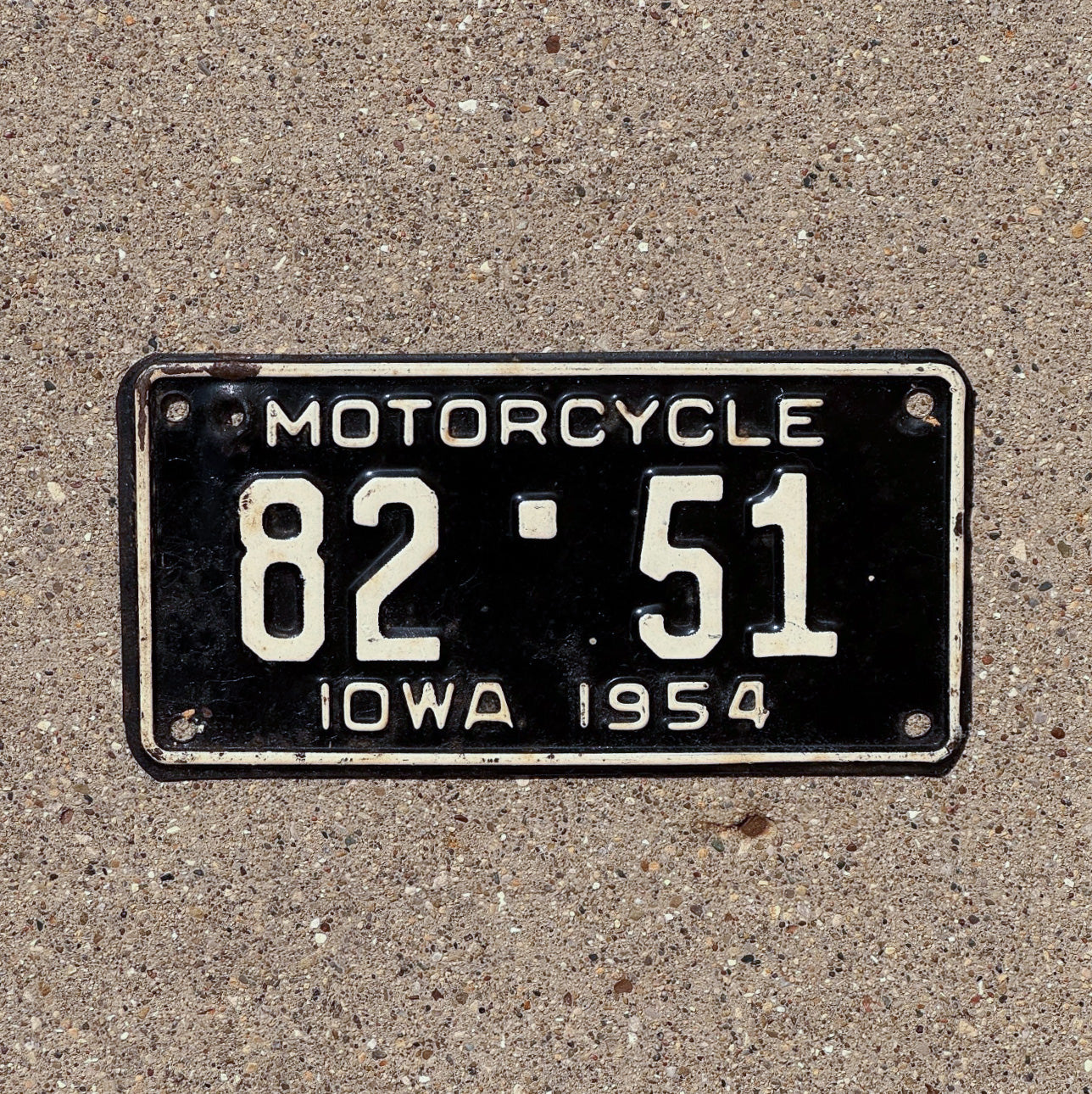Photo of a 1954 Iowa Motorcycle License Plate Auto Tag Garage Decor Vintage Low Number Two Digit Scott County 82 51 with original patina