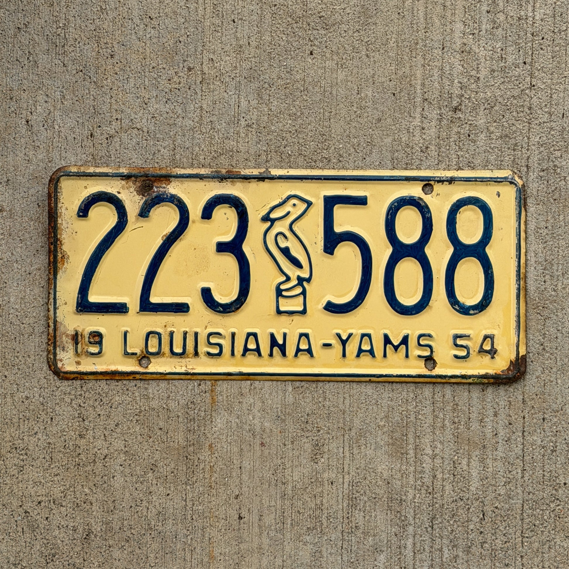 Photo of a 1954 Louisiana License Plate Auto Tag Garage Decor Vintage Iconic Pelican Yams Slogan 223 588 with original patina