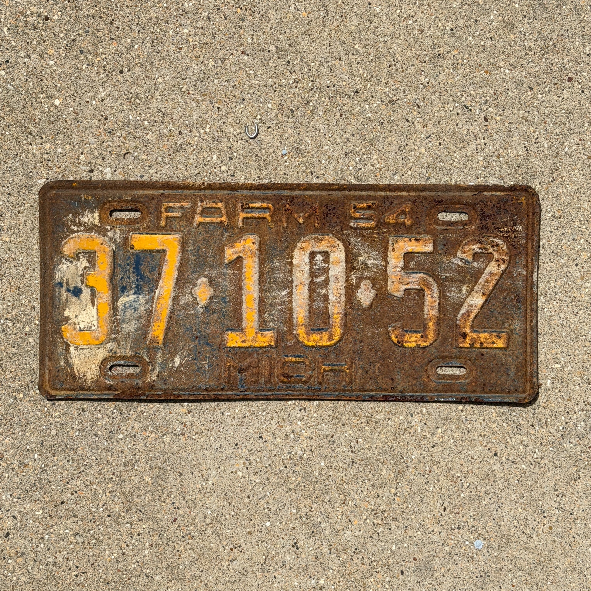Photo of a 1954 Michigan Farm License Plate Auto Tag Garage Decor Vintage 37 10 52 with original patina