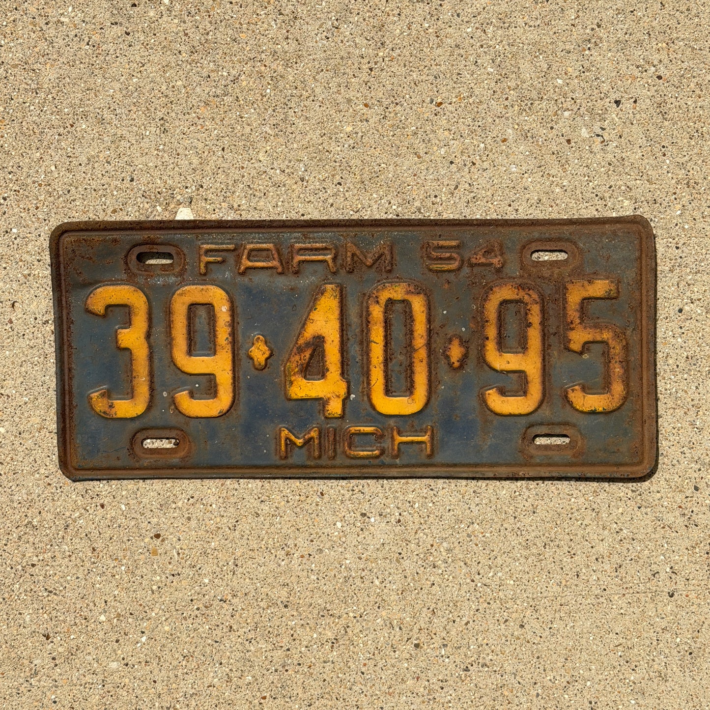 Photo of a 1954 Michigan Farm License Plate Auto Tag Garage Decor Vintage 39 40 95 with original patina