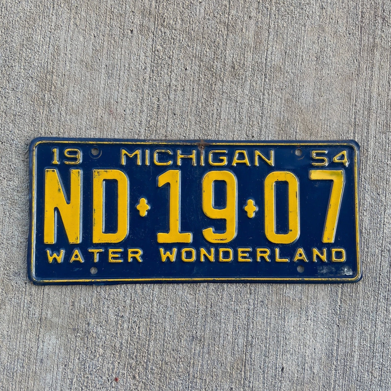 Photo of a 1954 Michigan License Plate Auto Tag Garage Decor Vintage ND 1907 with original patina