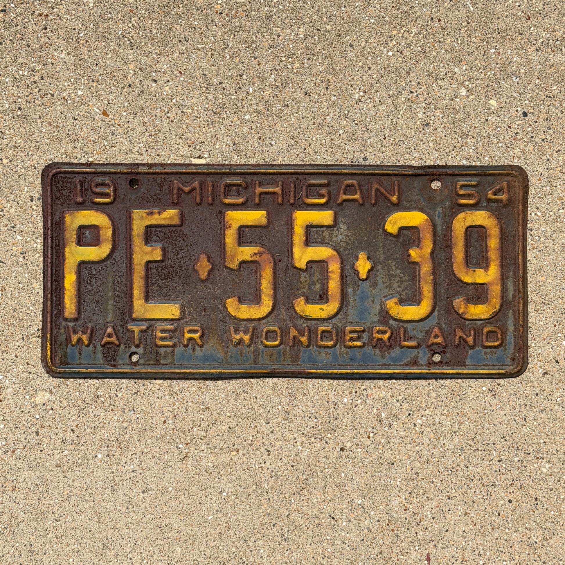 Photo of a 1954 Michigan License Plate Auto Tag Garage Decor Vintage PE 55 39 with original patina