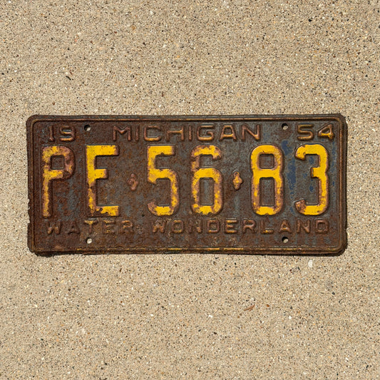 Photo of a 1954 Michigan License Plate Auto Tag Garage Decor Vintage PE 56 83 with original patina