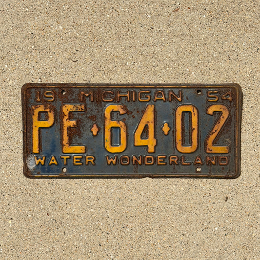 Photo of a 1954 Michigan License Plate Auto Tag Garage Decor Vintage PE 64 02 with original patina