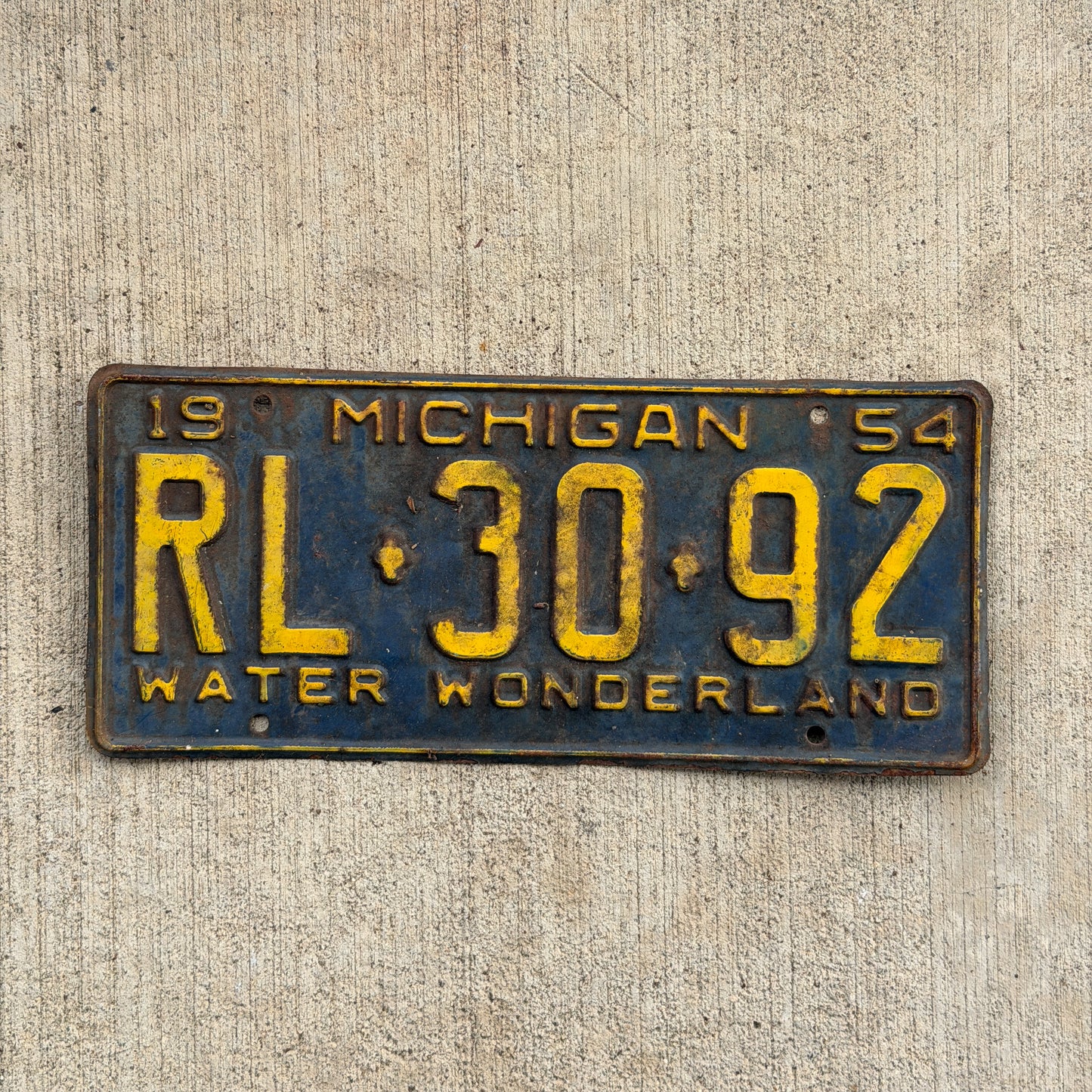 Photo of a 1954 Michigan License Plate Auto Tag Garage Decor Vintage RL 30 92 with original patina