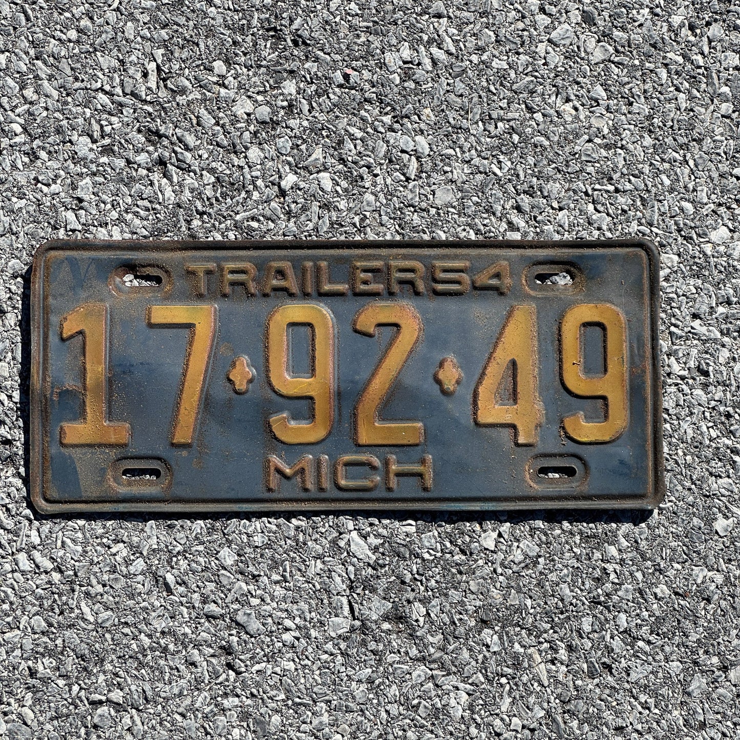 Photo of a 1954 Michigan Trailer License Plate Auto Tag Garage Decor Vintage 17 92 49
