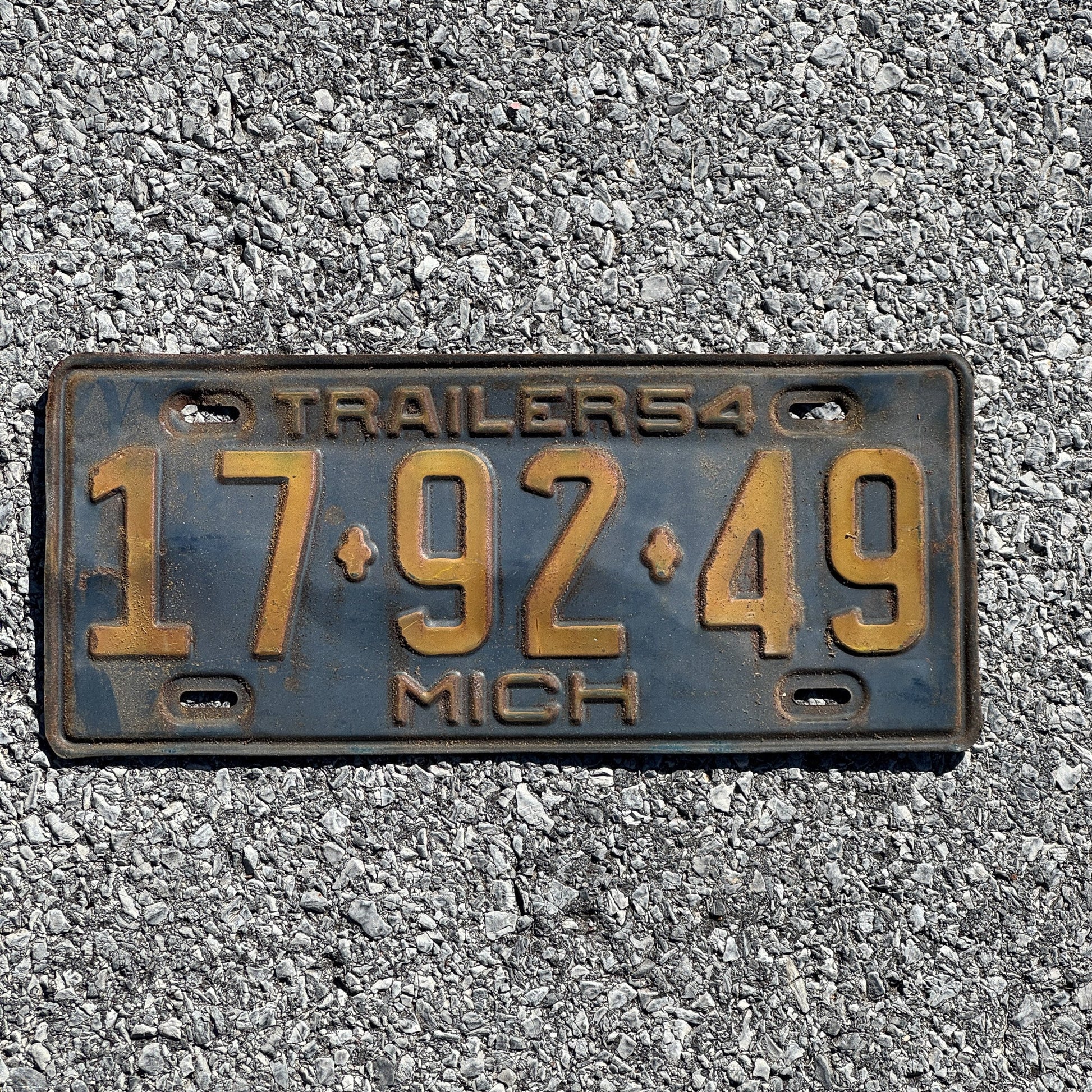 Photo of a 1954 Michigan Trailer License Plate Auto Tag Garage Decor Vintage 17 92 49