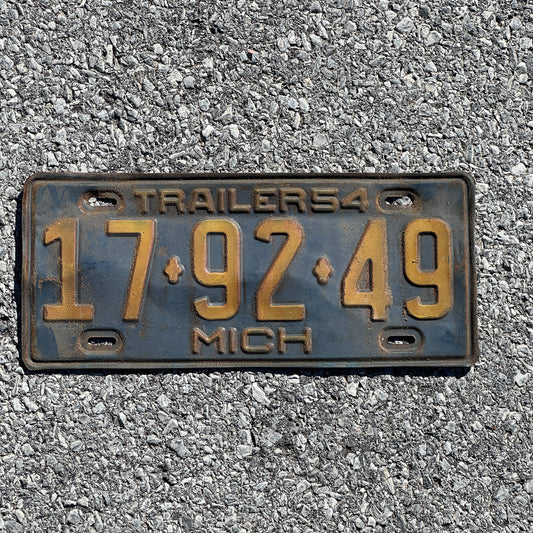 Photo of a 1954 Michigan Trailer License Plate Auto Tag Garage Decor Vintage 17 92 49