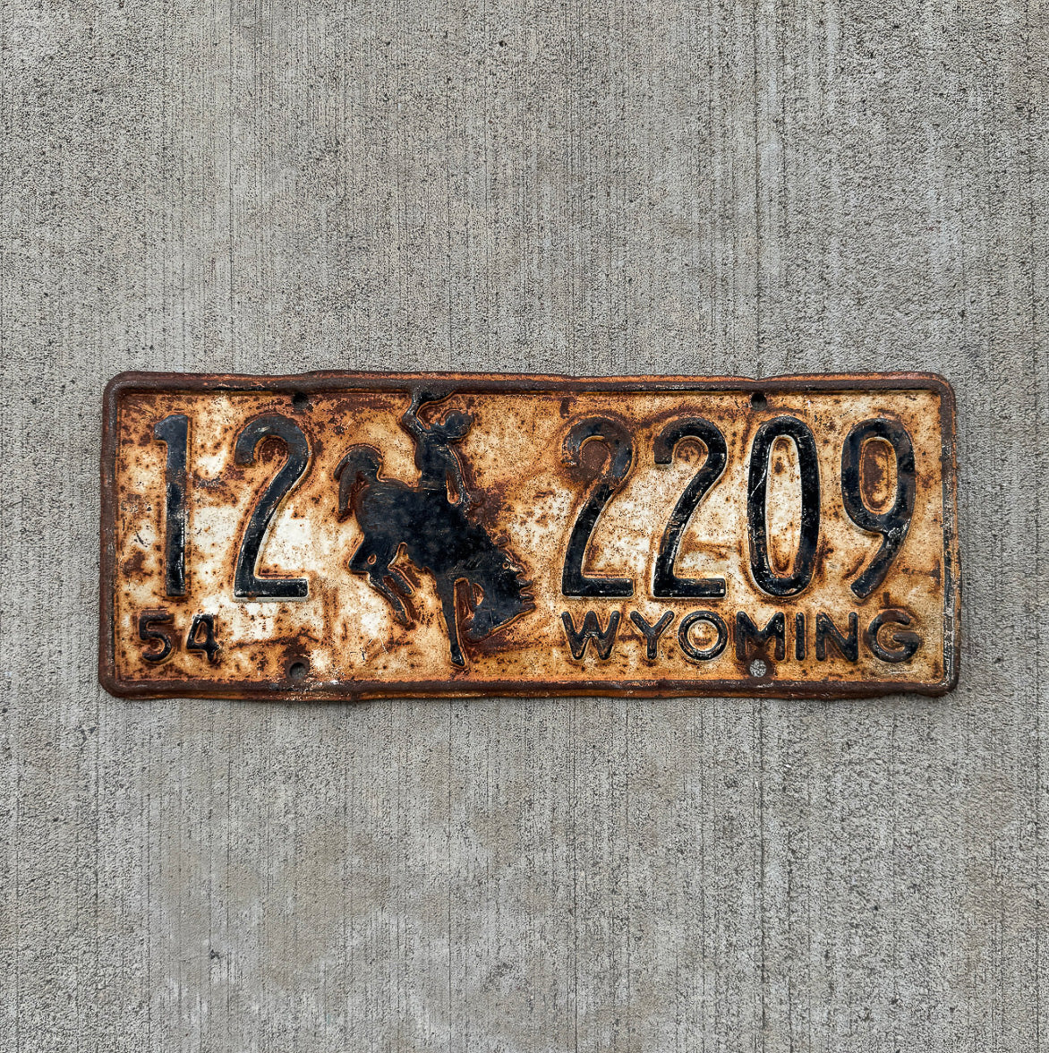 Photo of a 1954 Wyoming License Plate Auto Tag Garage Decor Vintage Cowboy Rodeo Rustic 12 2209 with original patina