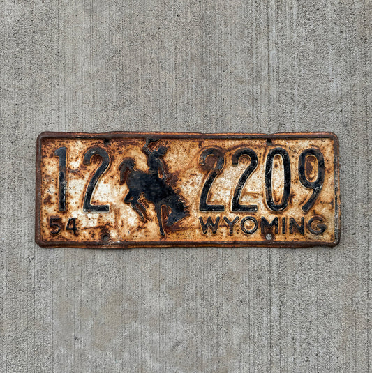 Photo of a 1954 Wyoming License Plate Auto Tag Garage Decor Vintage Cowboy Rodeo Rustic 12 2209 with original patina
