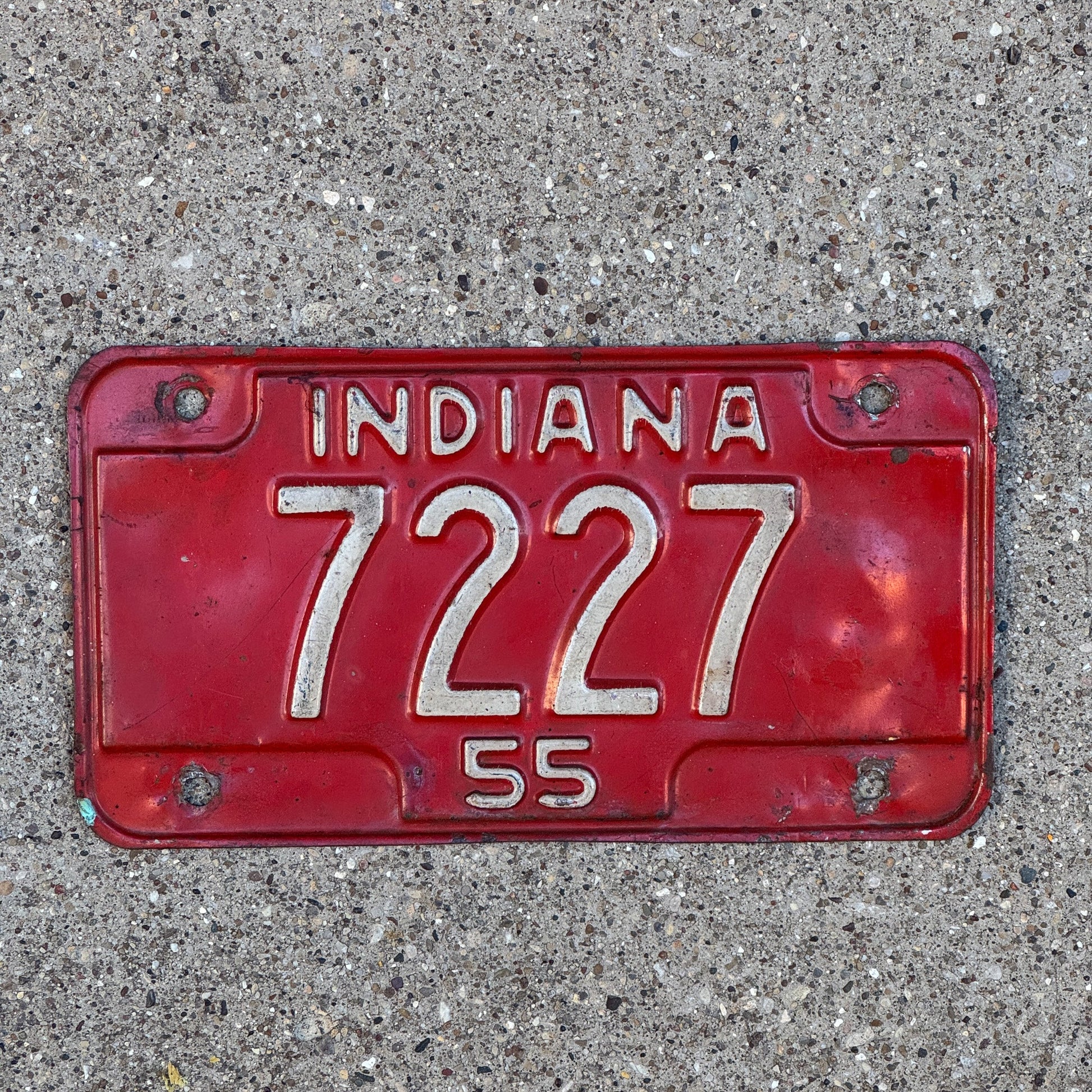 Photo of a 1955 Indiana Motorcycle License Plate Auto Tag Garage Decor Vintage Low Number Four Digit Palindrome 7227 with original patina