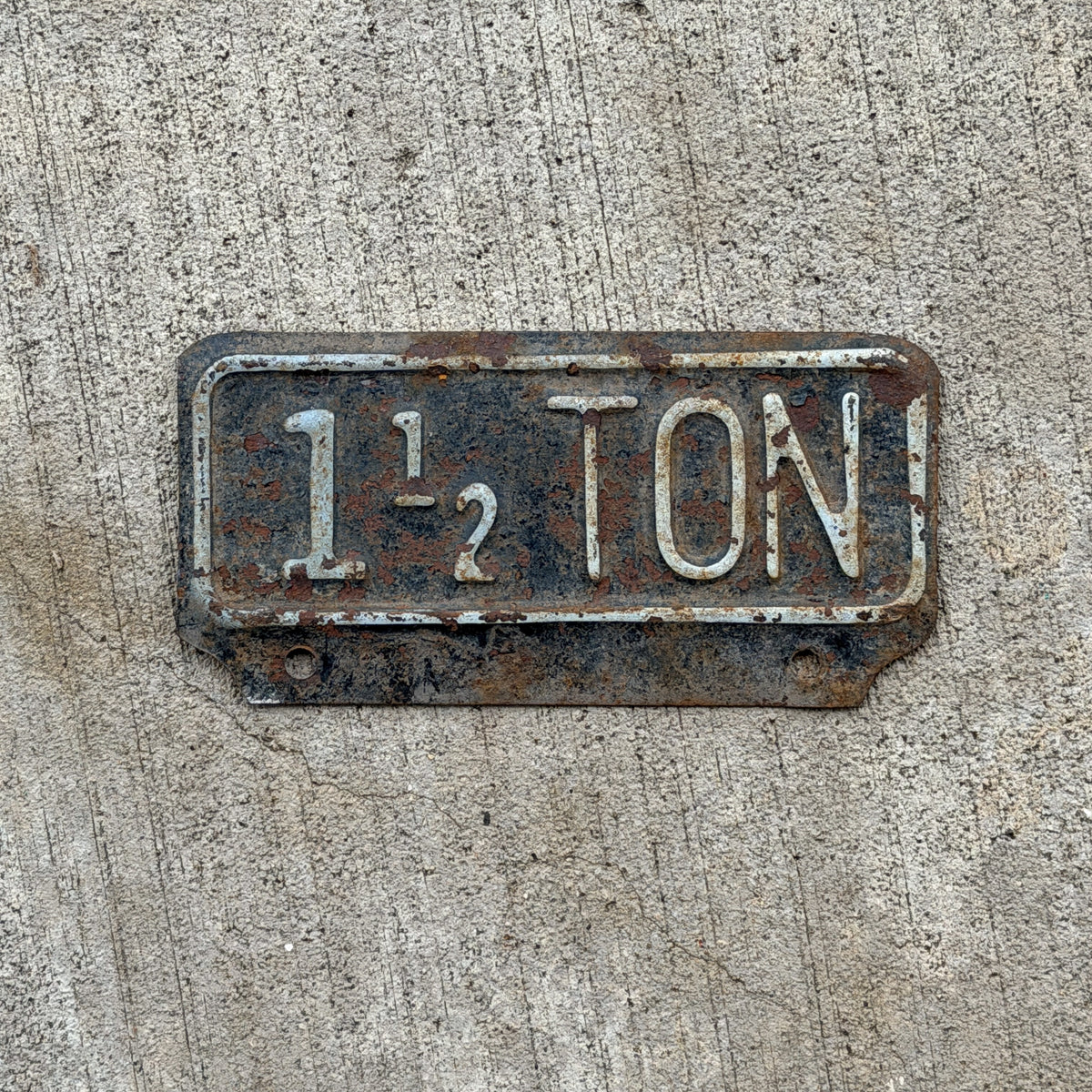 Photo of a 1955 Kansas Truck License Plate Auto Tag Garage Decor Vintage 1 1/2 Ton Weight Supplementary Topper with original patina