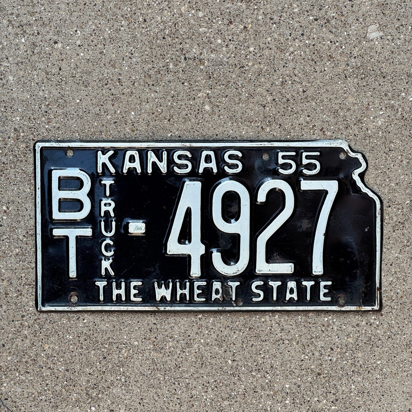 Photo of a 1955 Kansas Truck License Plate Auto Tag Garage Decor Vintage Barton County State Shape BT 4927
