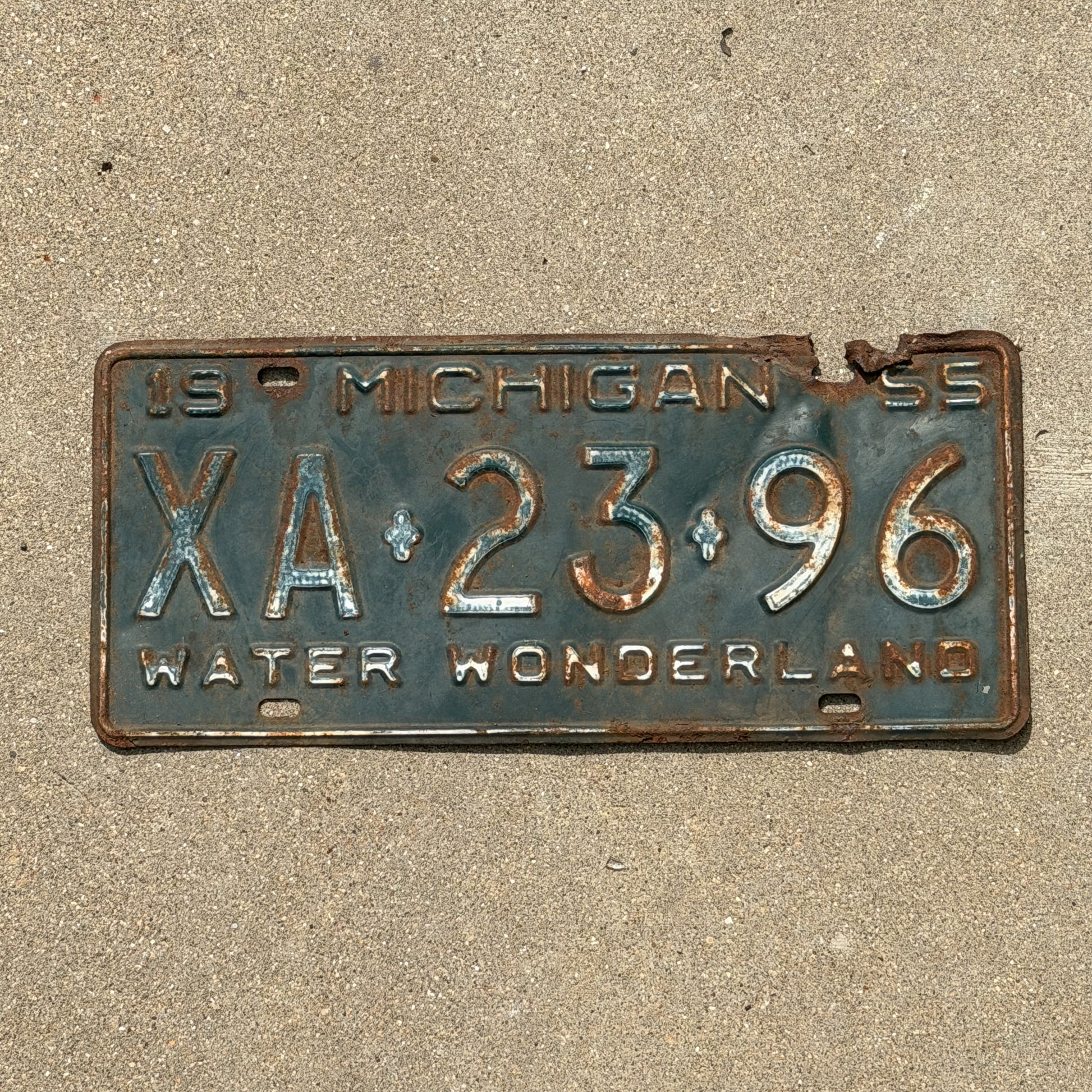 Photo of a 1955 Michigan License Plate Auto Tag Garage Decor Vintage XA 23 96 with original patina