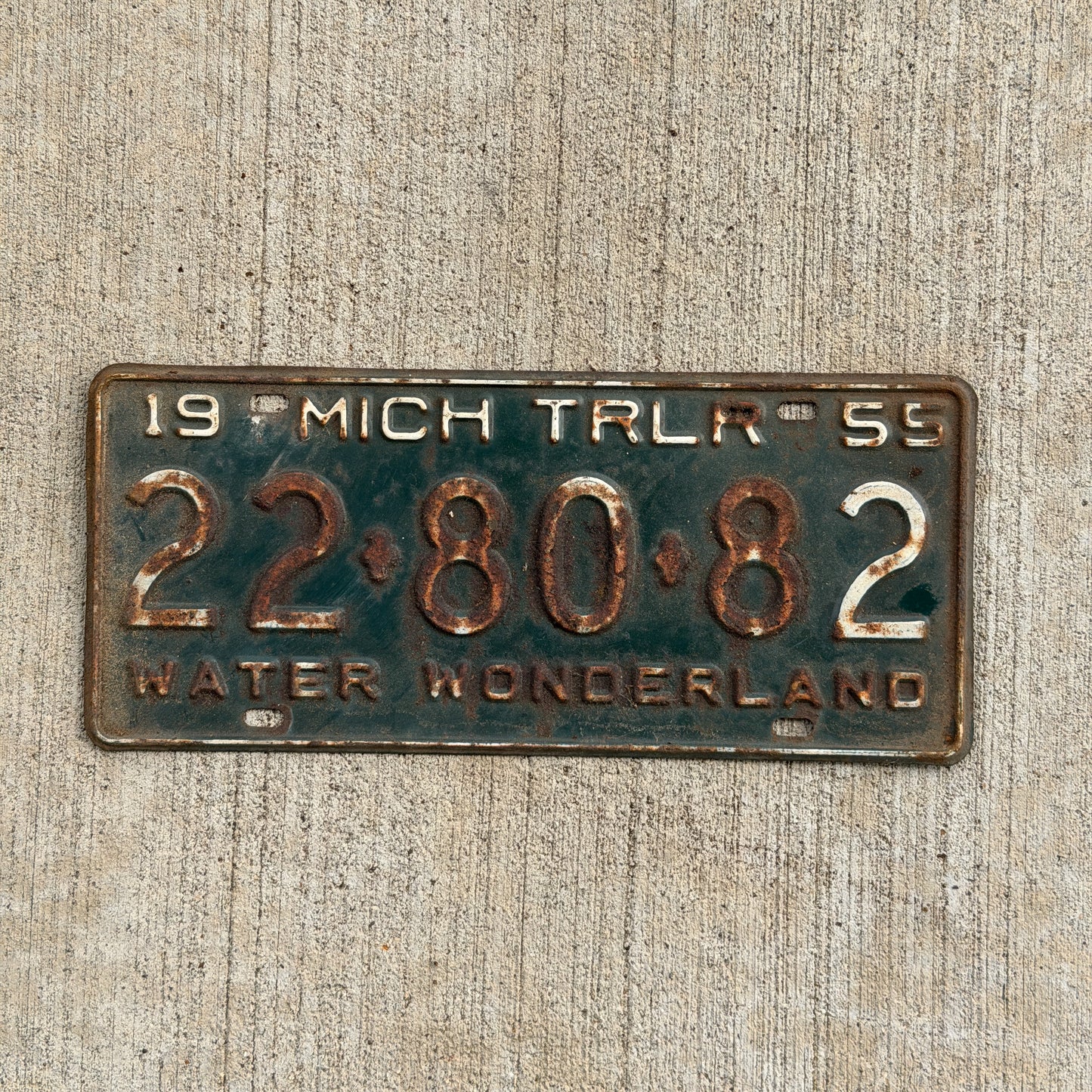 Photo of a 1955 Michigan Trailer License Plate Auto Tag Garage Decor Vintage 22 80 82 with original patina