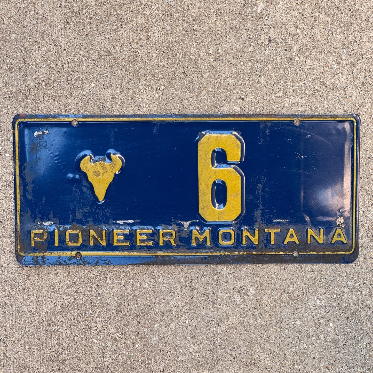 Photo of a 1955 Montana Pioneer License Plate Auto Tag 2 Garage Decor Bison Head Low Number Single Digit 6 with original patina