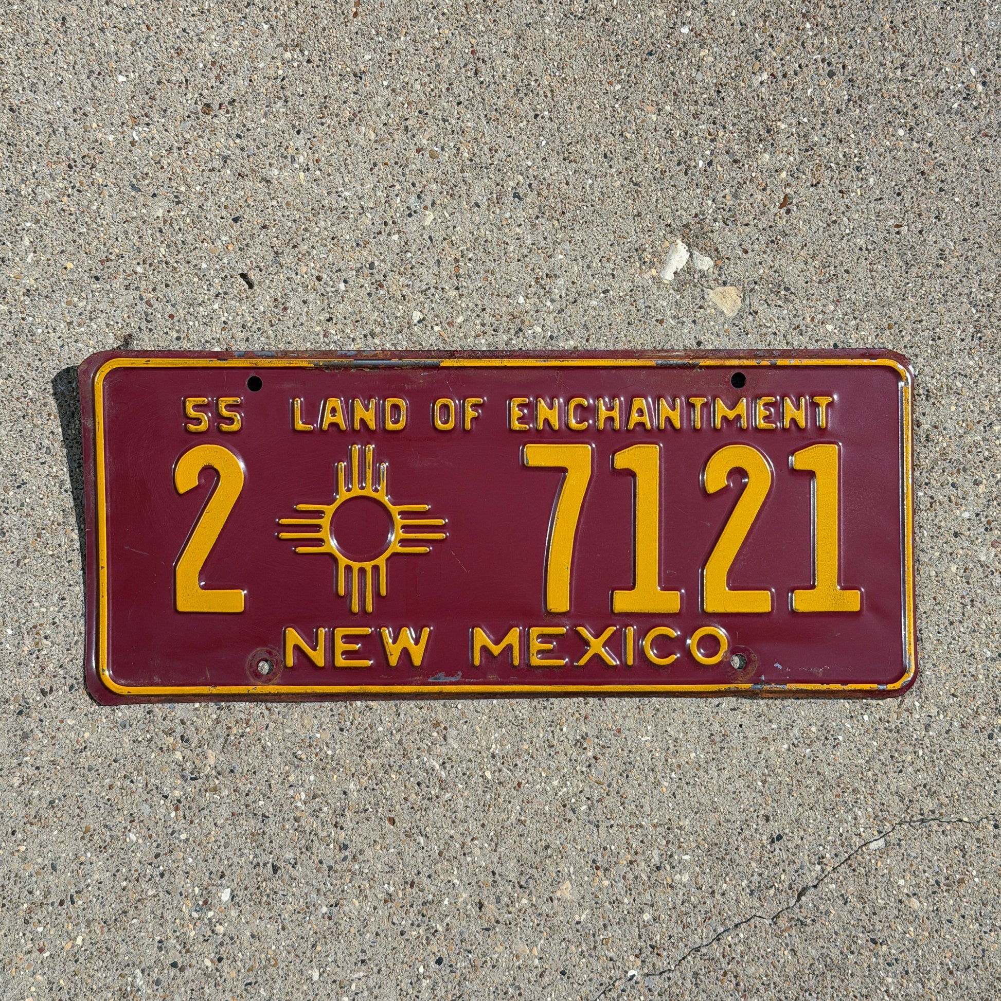 Photo of a 1955 New Mexico License Plate Auto Tag Garage Decor Vintage Zia Spacer 2 7121 with original patina